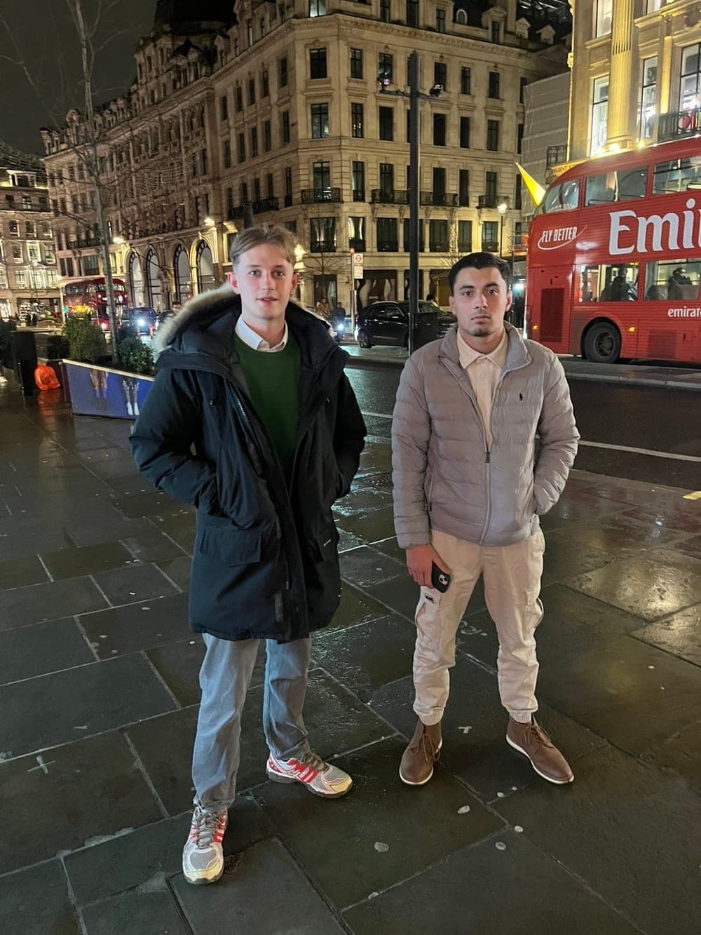 Daniel and his then co-founder Max on Regent Street in London at night, a red bus behind them